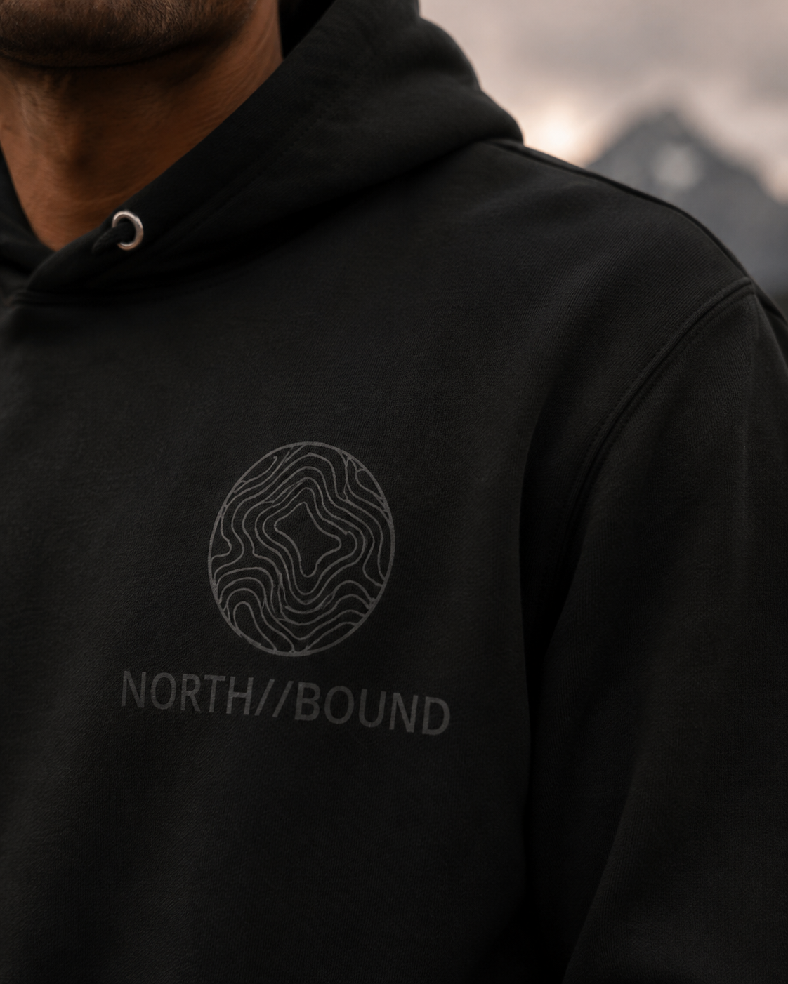 NORTH//BOUND topographic chest logo detail on Explorer Hoodie